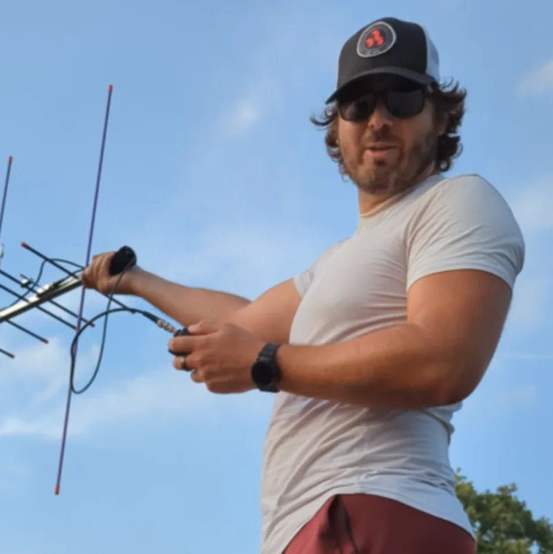 Jared Ringenberg holding outdoor communications equipment