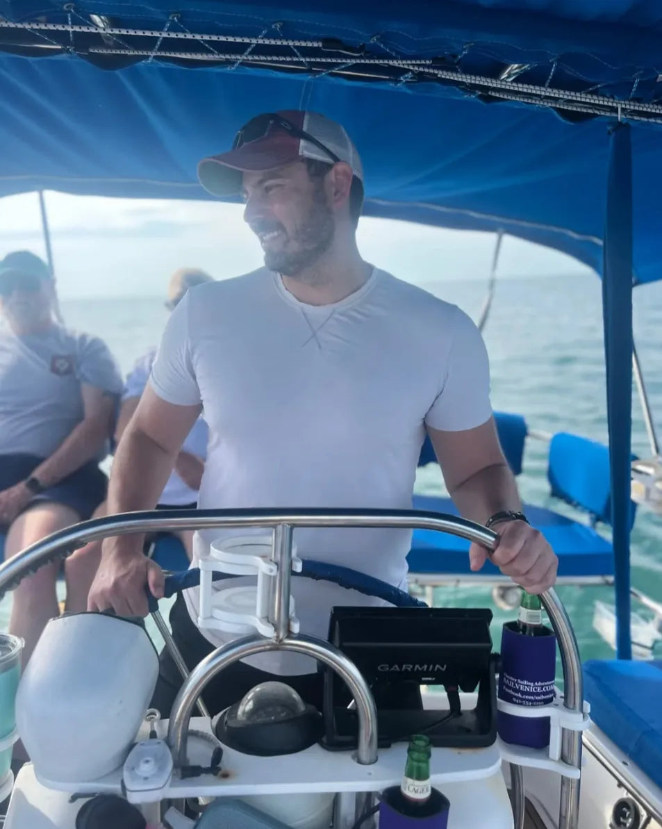 Jared Ringenberg at the helm of a sailboat
