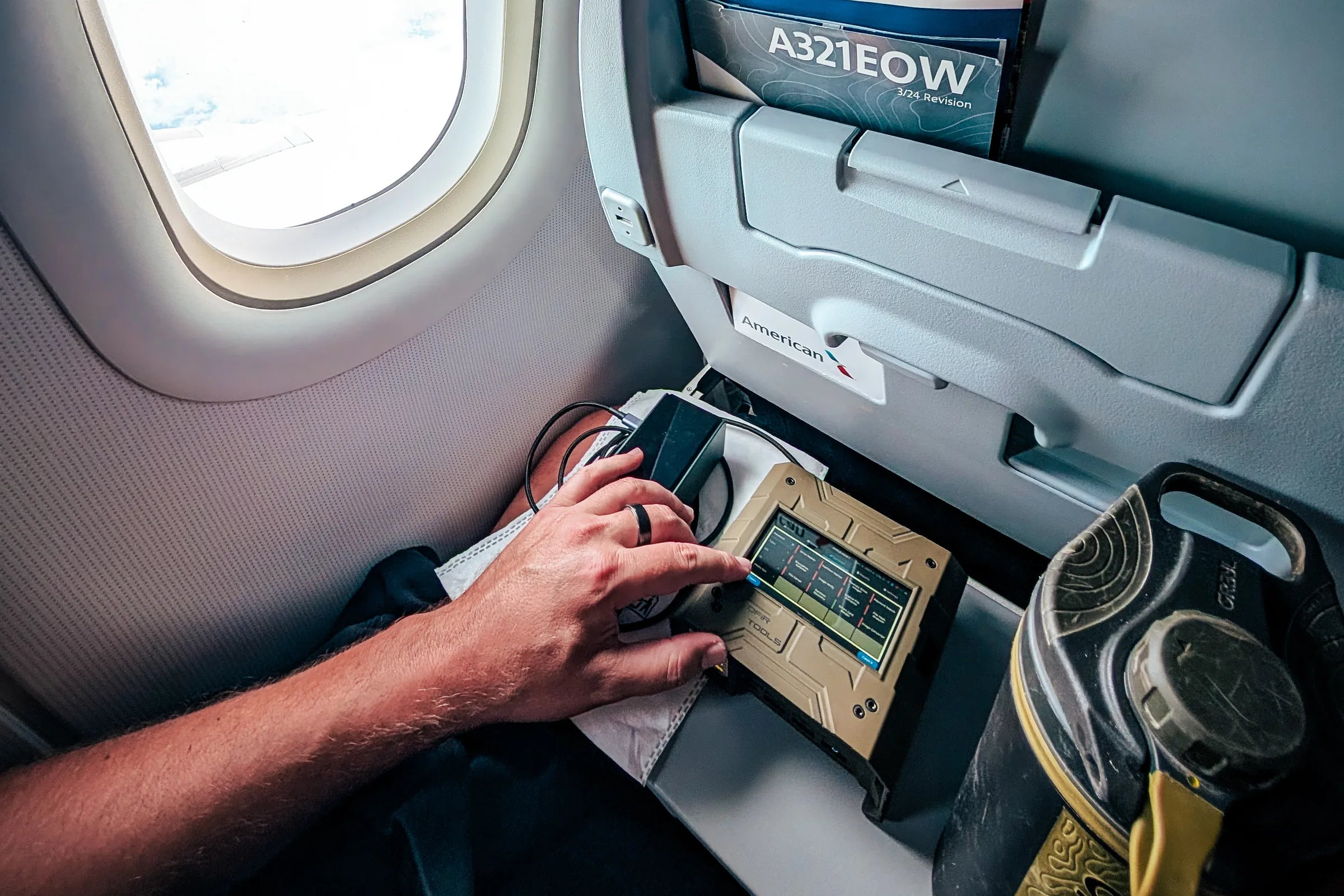 Operator using a Shield-399 unit while seated aboard an aircraft