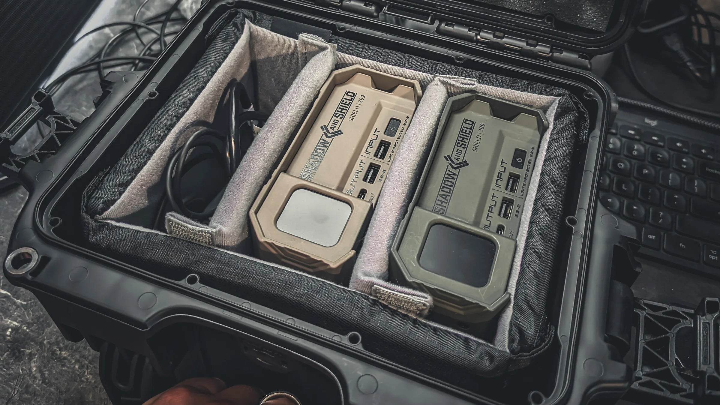 Two Shield-399 units secured in an open Nanuk 908 case with customizable dividers